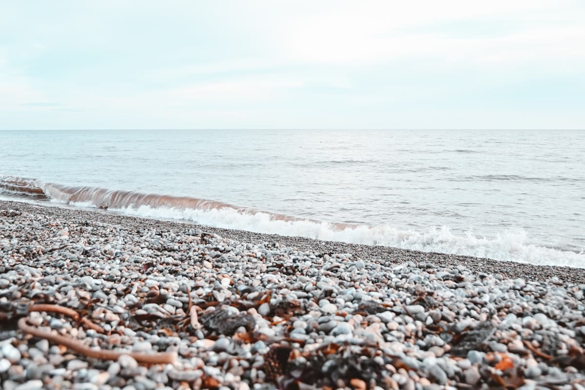 Pebble shoreline at Portishead Beach with views across the Bristol Channel toward the Welsh coast