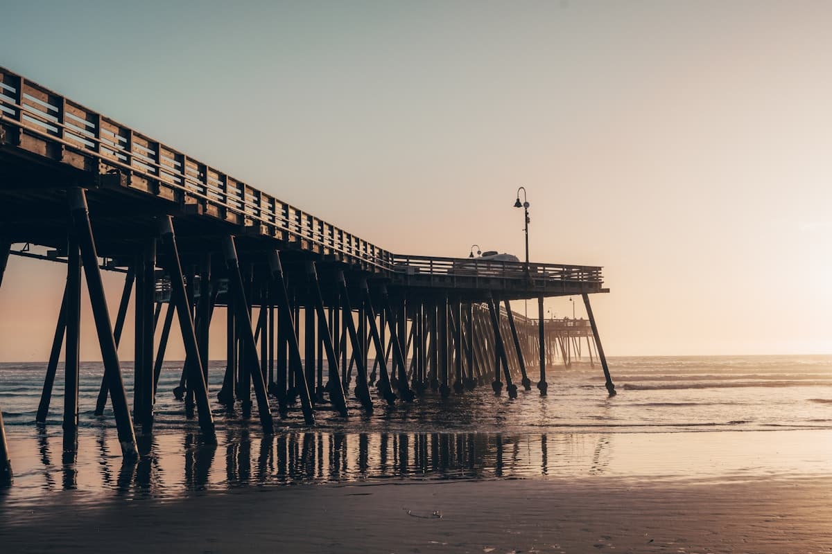 Pismo Beach pier at sunset with golden light on the water