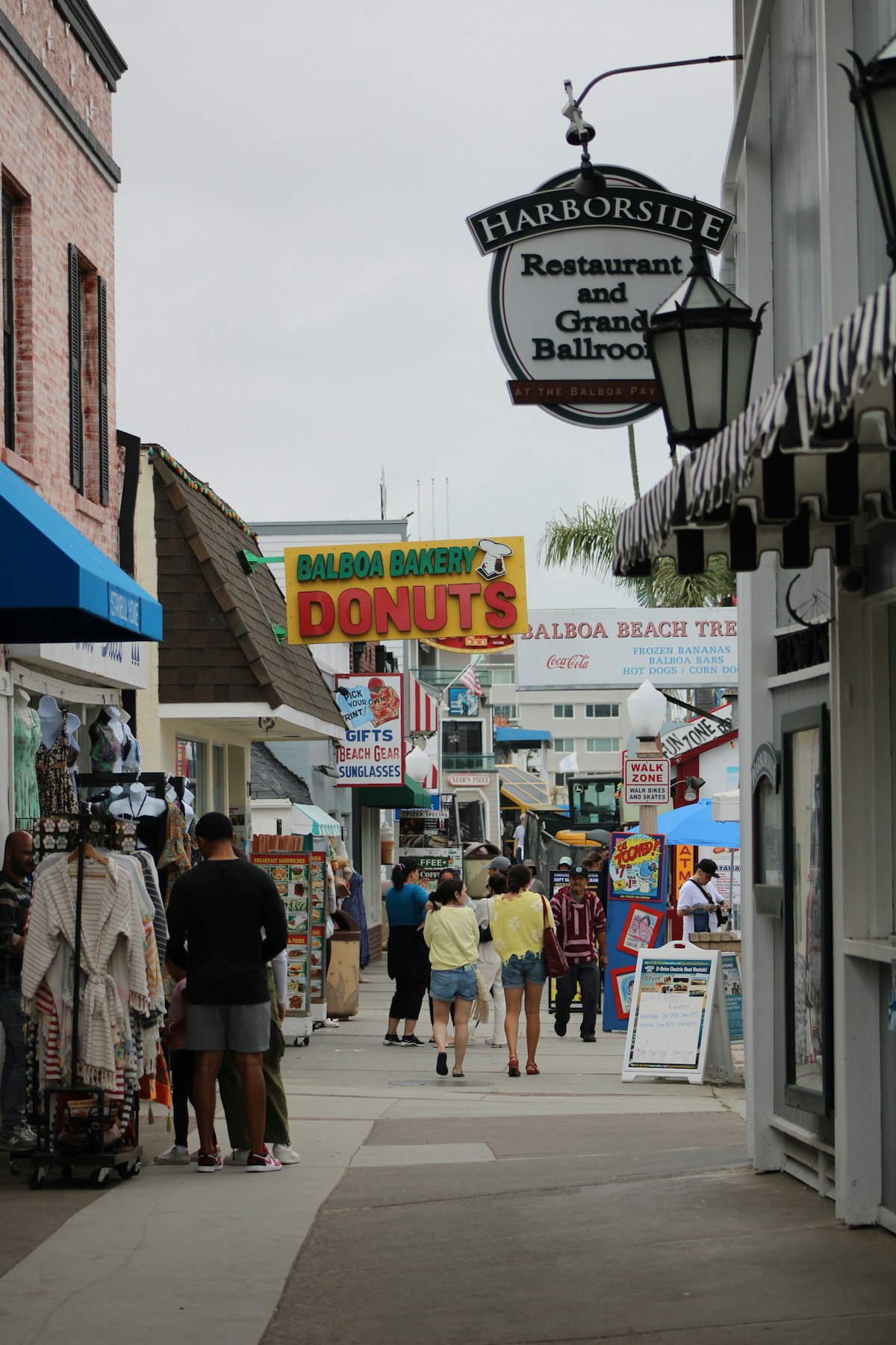 Balboa Island shops with Balboa Bakery Donuts and Harborside Restaurant signs